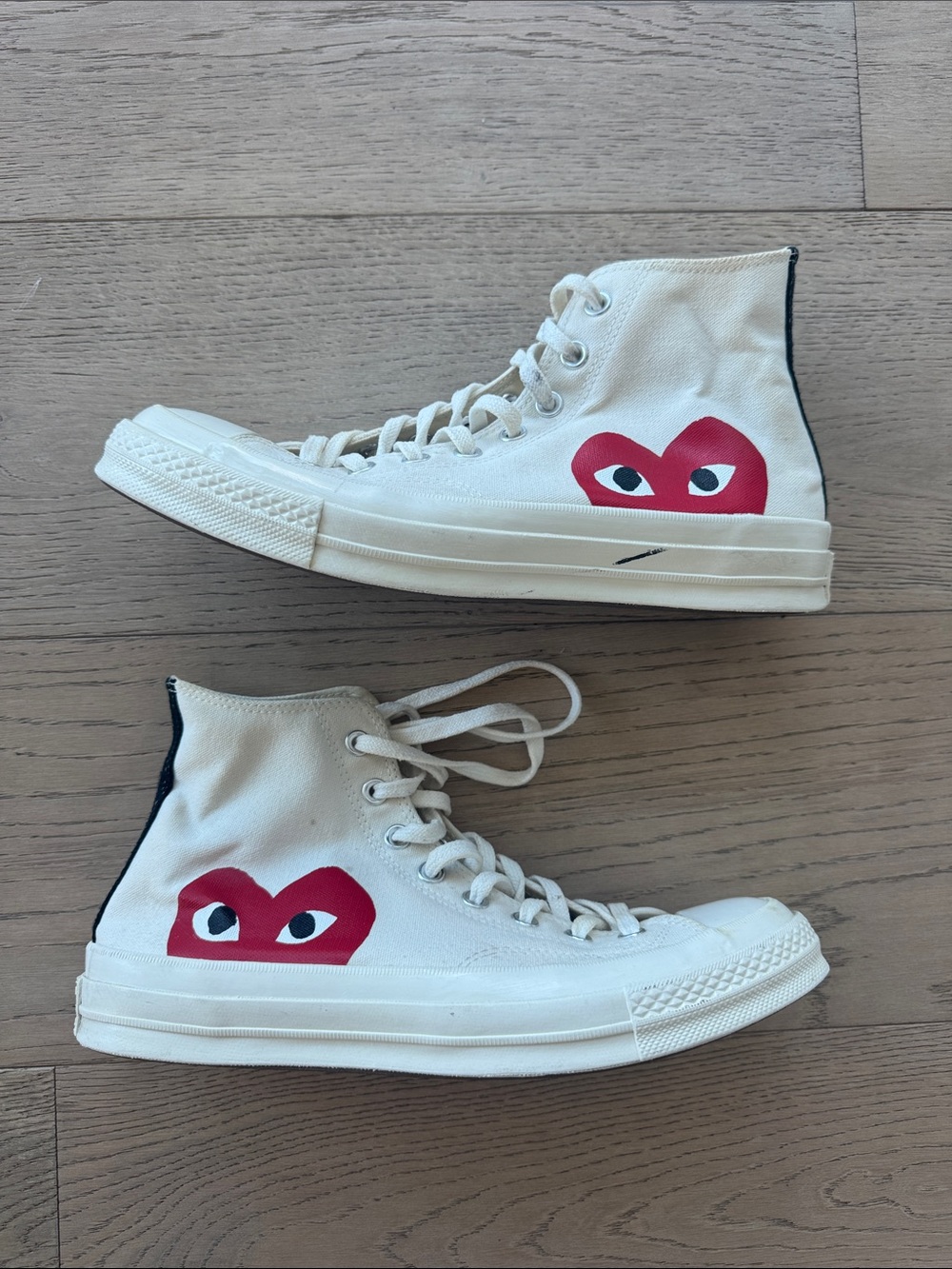 Comme des Garçons Play Crème colored Converse High Tops